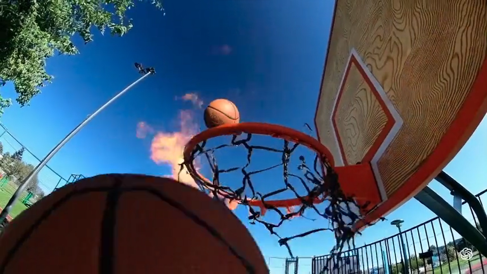 空中にボールがあるバスケットボールのフープDescription automatically generated
